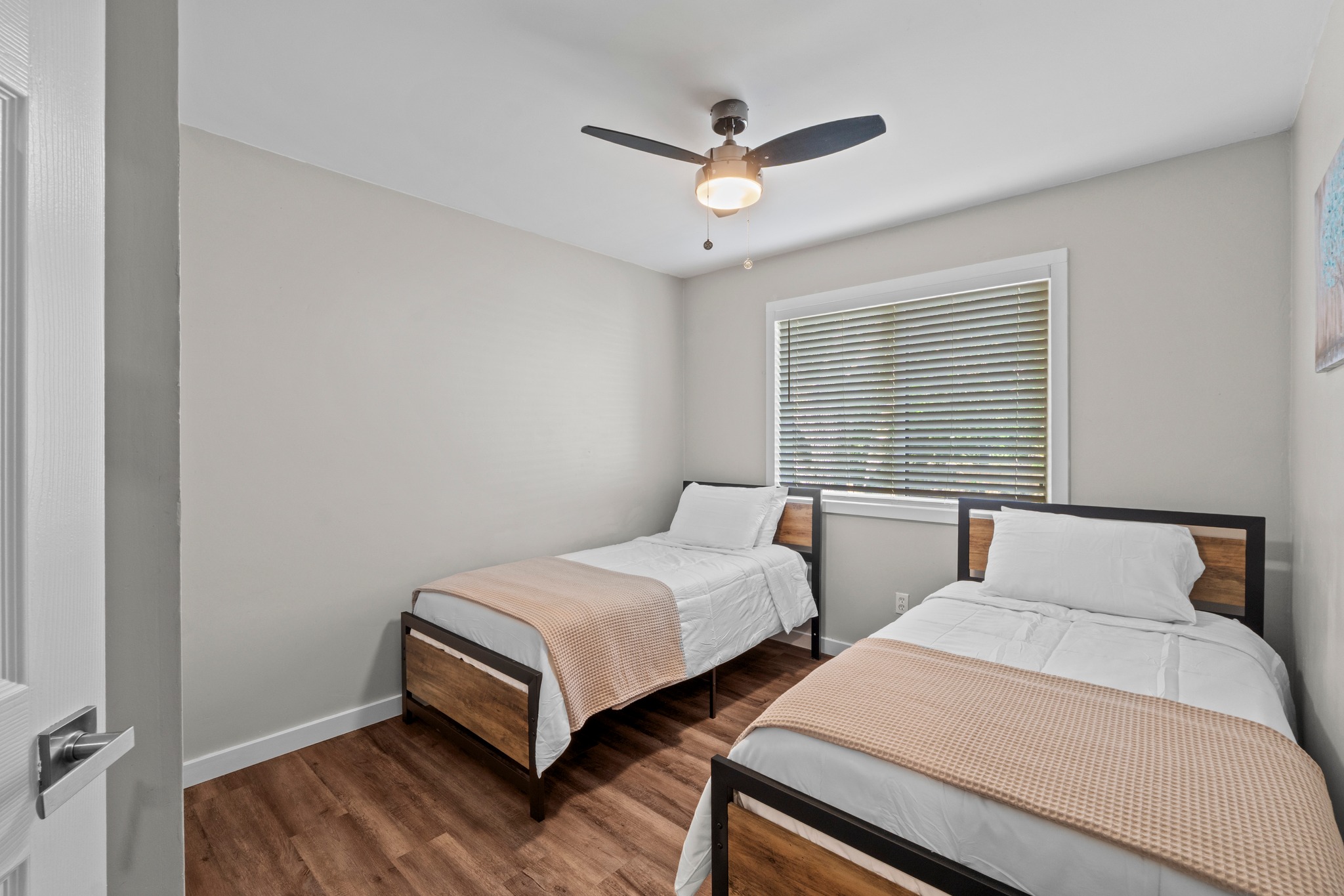 11811 Rotherham Drive Austin, TX 78754 - Photo 27 of 37 Hardwood-style flooring and natural light create a welcoming bedroom retreat.