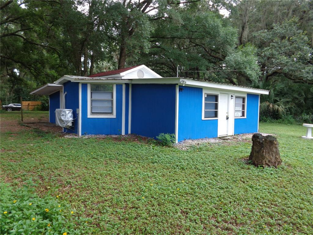 a front view of house with yard and outdoor seating