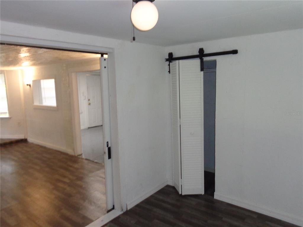 2878 Northeast 161st Street Citra, FL 32113 - Photo 14 of 38 a view of empty room with wooden floor and fan