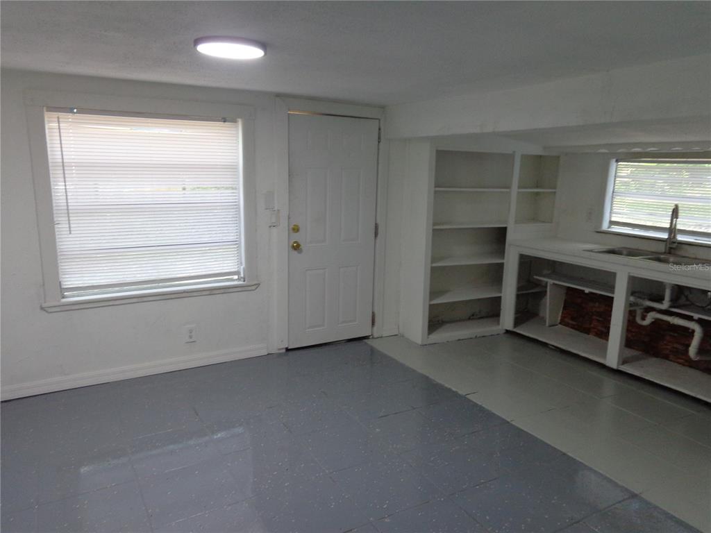 2878 Northeast 161st Street Citra, FL 32113 - Photo 15 of 38 an empty room with a fireplace and windows
