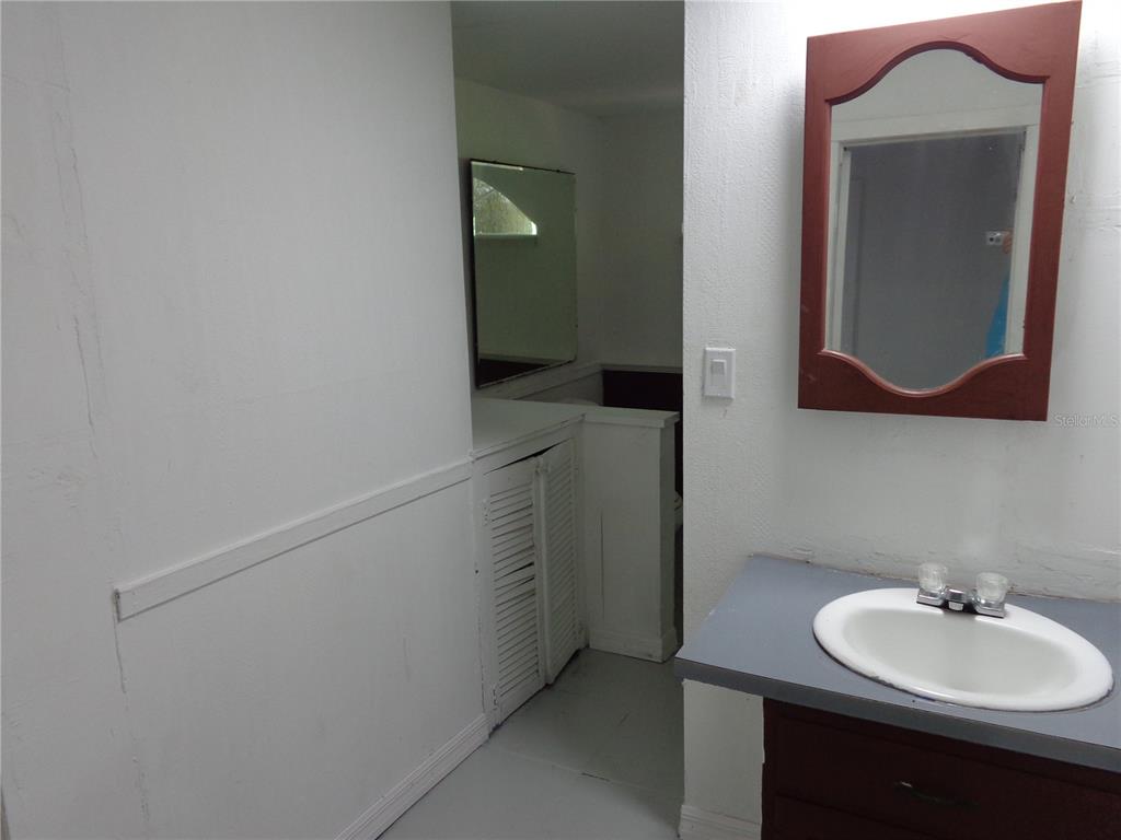 2878 Northeast 161st Street Citra, FL 32113 - Photo 20 of 38 a bathroom with a sink and a mirror