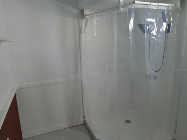 a bathroom with a glass shower door