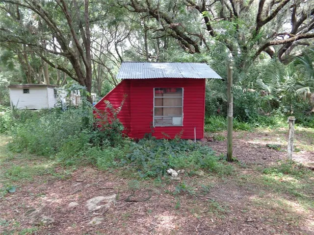 a view of a red house with a yard