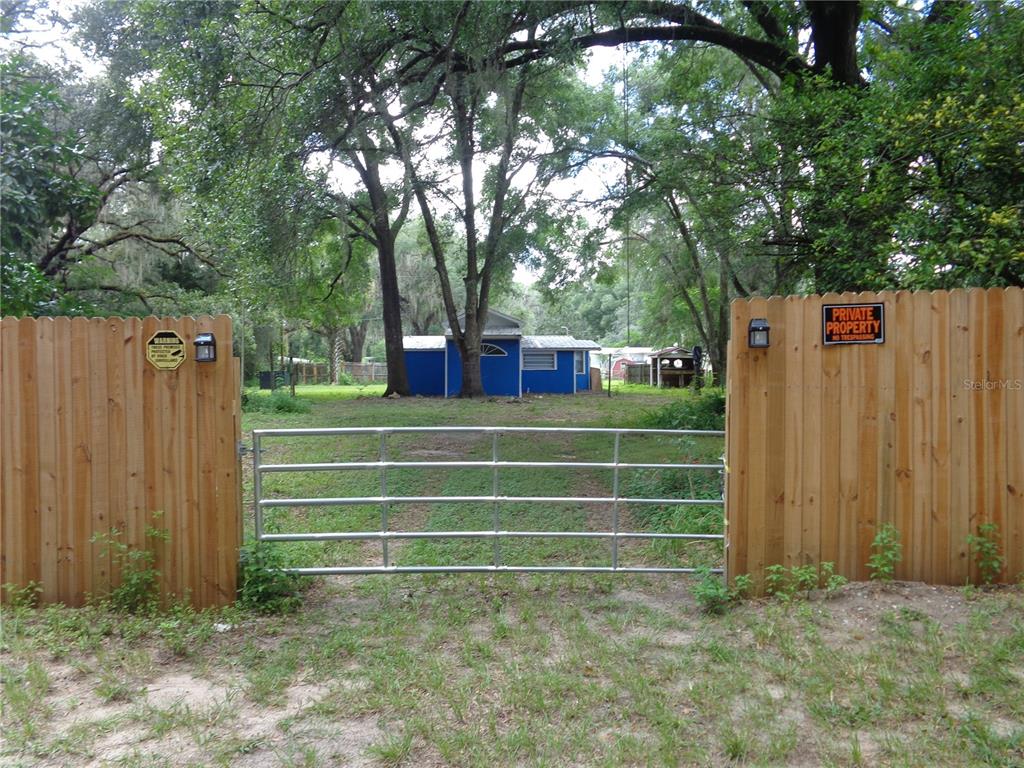 2878 Northeast 161st Street Citra, FL 32113 - Photo 35 of 38 a view of a tennis ground with large trees