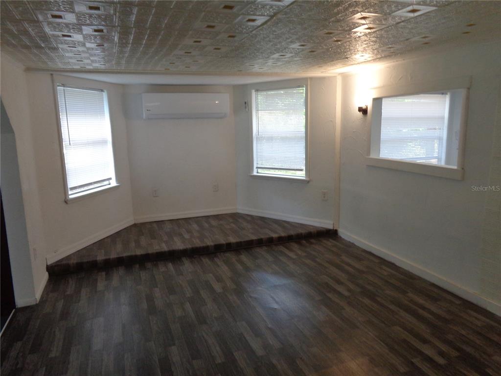 2878 Northeast 161st Street Citra, FL 32113 - Photo 10 of 38 a view of an empty room with wooden floor and a window