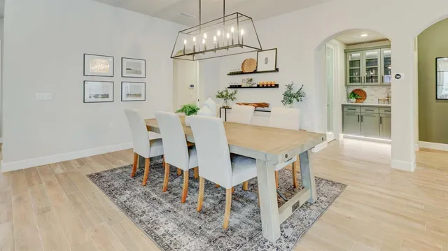 a view of a dining room with furniture and wooden floor