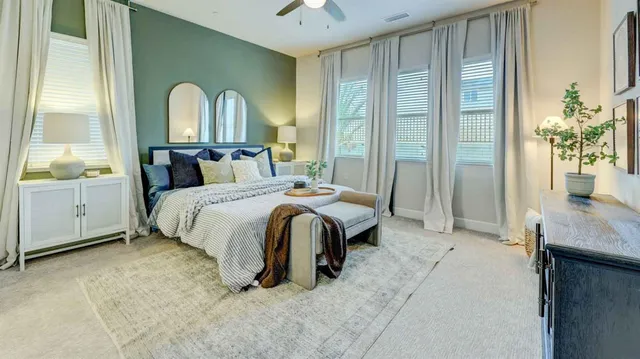 a bedroom with a bed and a potted plant