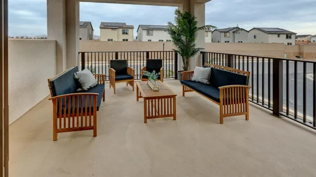 a view of a balcony with chairs