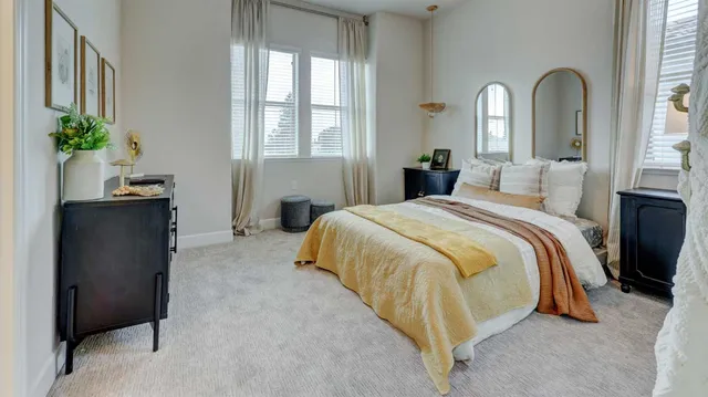 a bed room with a bed and a potted plant