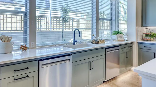 a kitchen with a sink and large window