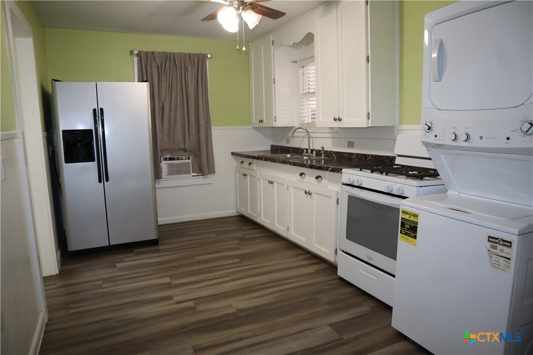 a kitchen with stainless steel appliances granite countertop a stove a refrigerator and a microwave