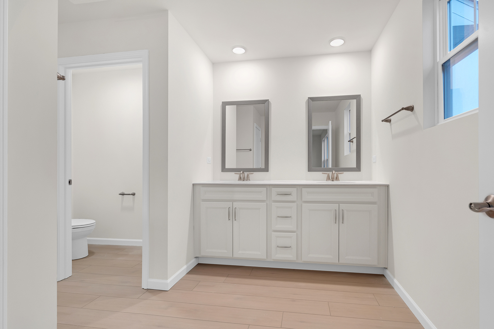 668 Switchgrass Way Bolingbrook, IL 60490 - Photo 12 of 21 a bathroom with a sink a toilet and a mirror
