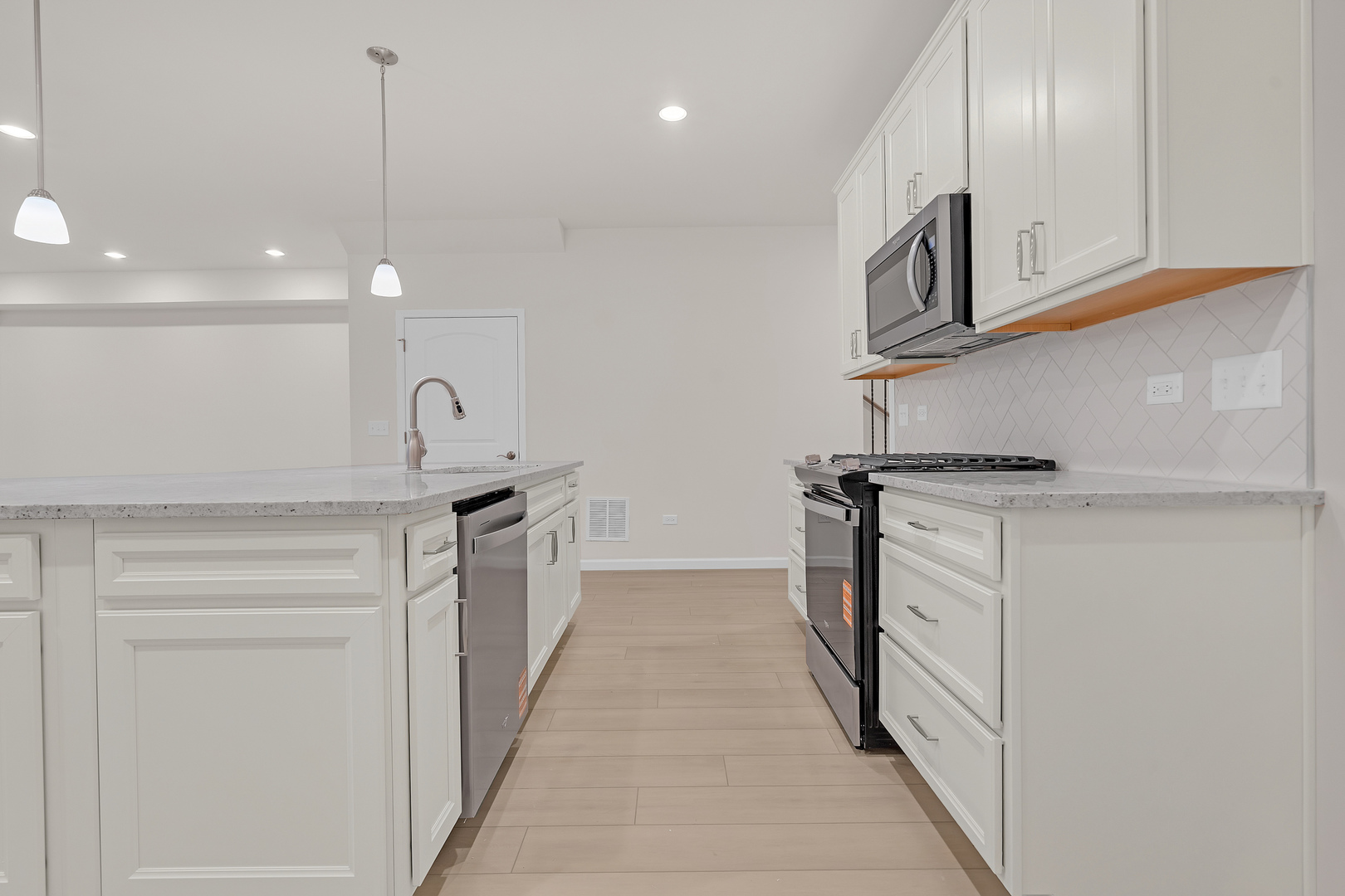 668 Switchgrass Way Bolingbrook, IL 60490 - Photo 7 of 21 a kitchen with stainless steel appliances granite countertop a sink and a stove