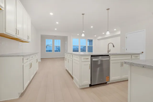 a large kitchen with white cabinets