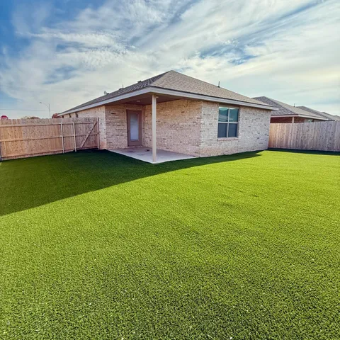 a backyard view with a garden