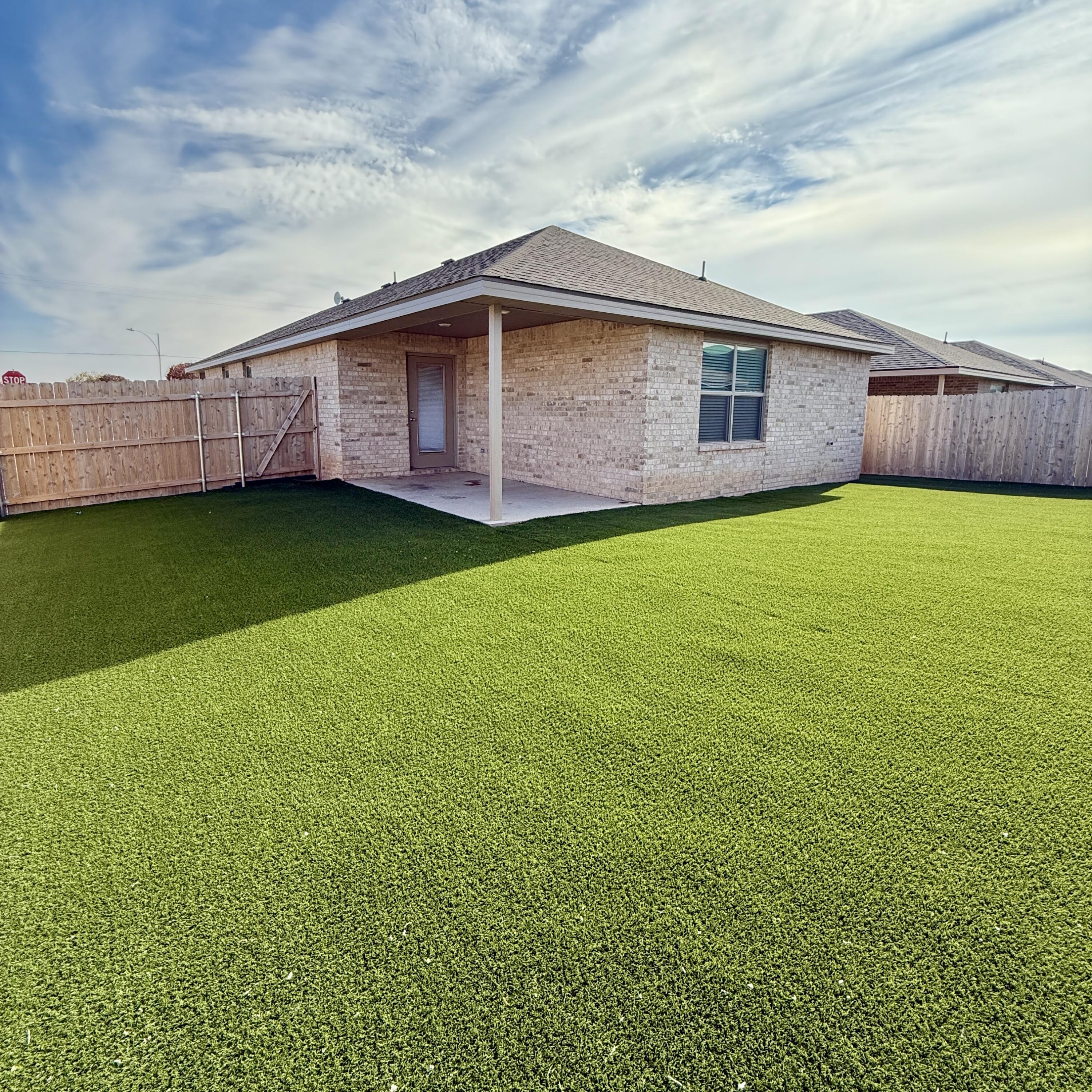 7702 Elm Avenue Lubbock, TX 79404 - Photo 15 of 16 a backyard view with a garden