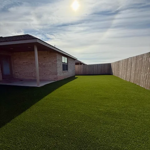 a view of an house with backyard space and garden
