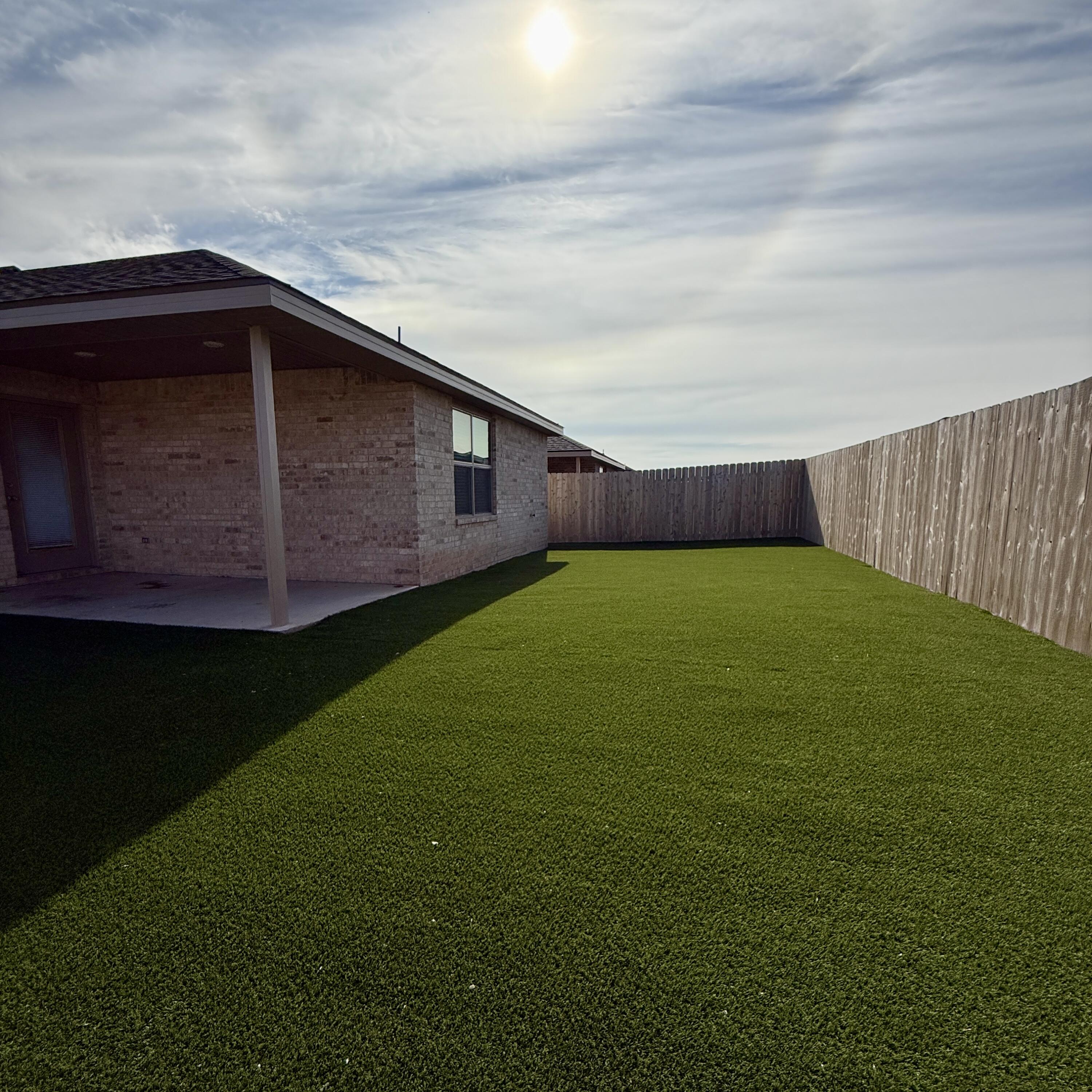 7702 Elm Avenue Lubbock, TX 79404 - Photo 16 of 16 a view of an house with backyard space and garden