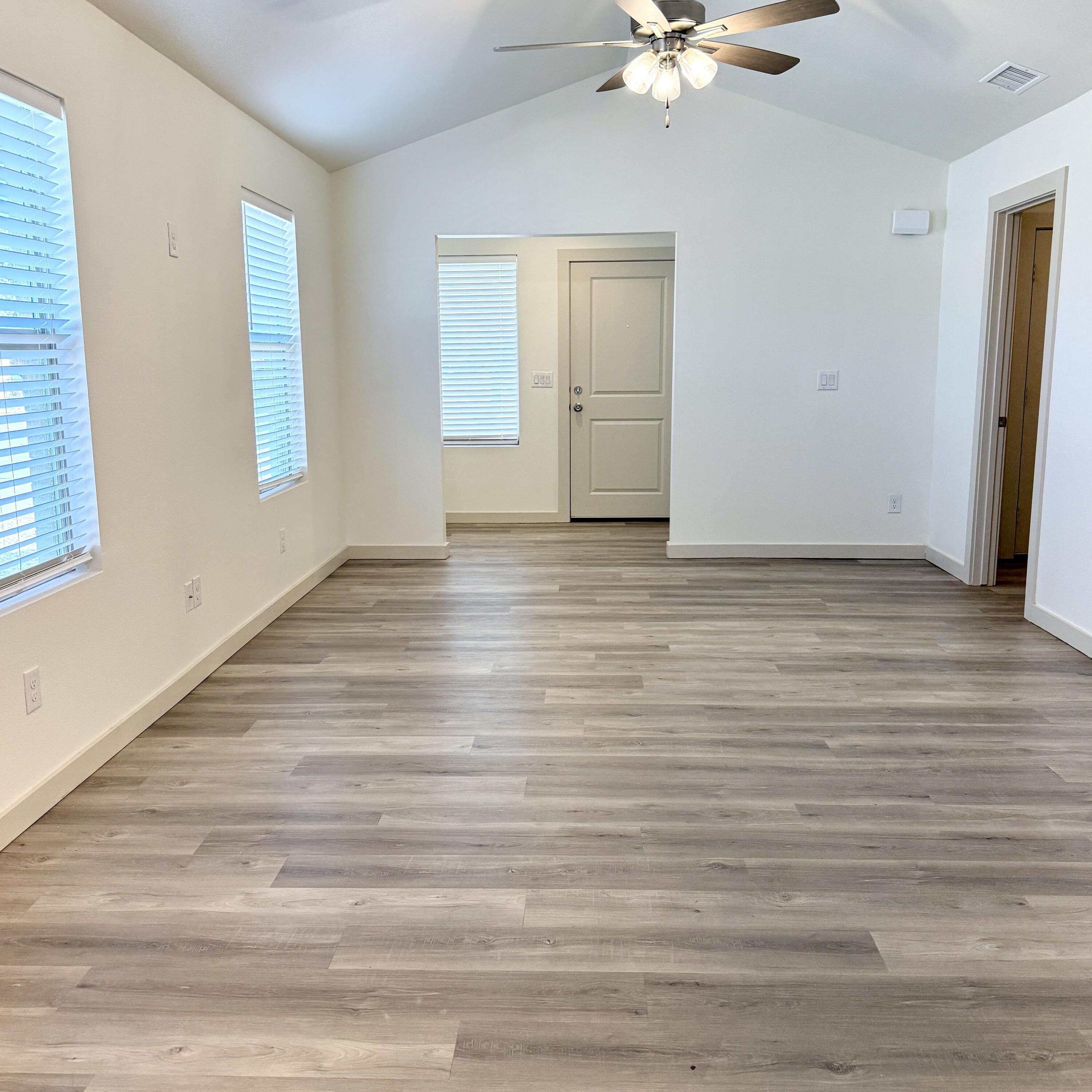 7702 Elm Avenue Lubbock, TX 79404 - Photo 2 of 16 a view of an empty room with a window and a ceiling fan