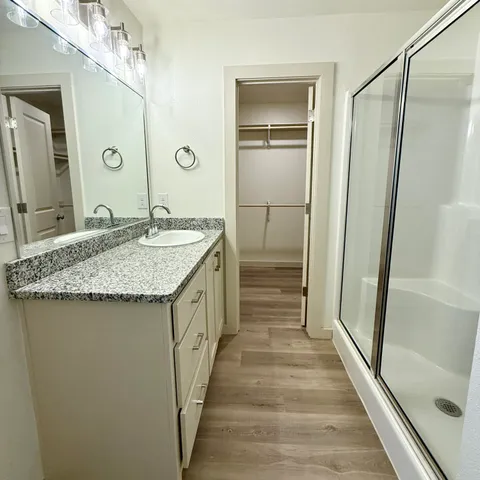 a bathroom with a granite countertop sink and a mirror