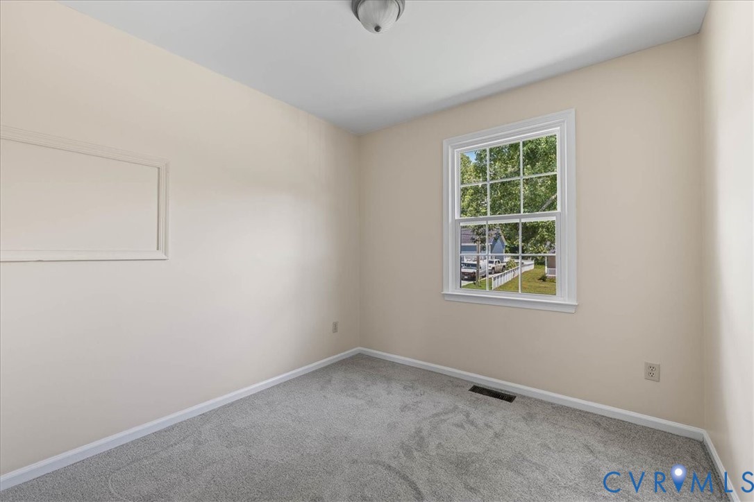 1618 Old Iron Road Hopewell, VA 23860 - Photo 18 of 25 Carpeted spare room featuring baseboards