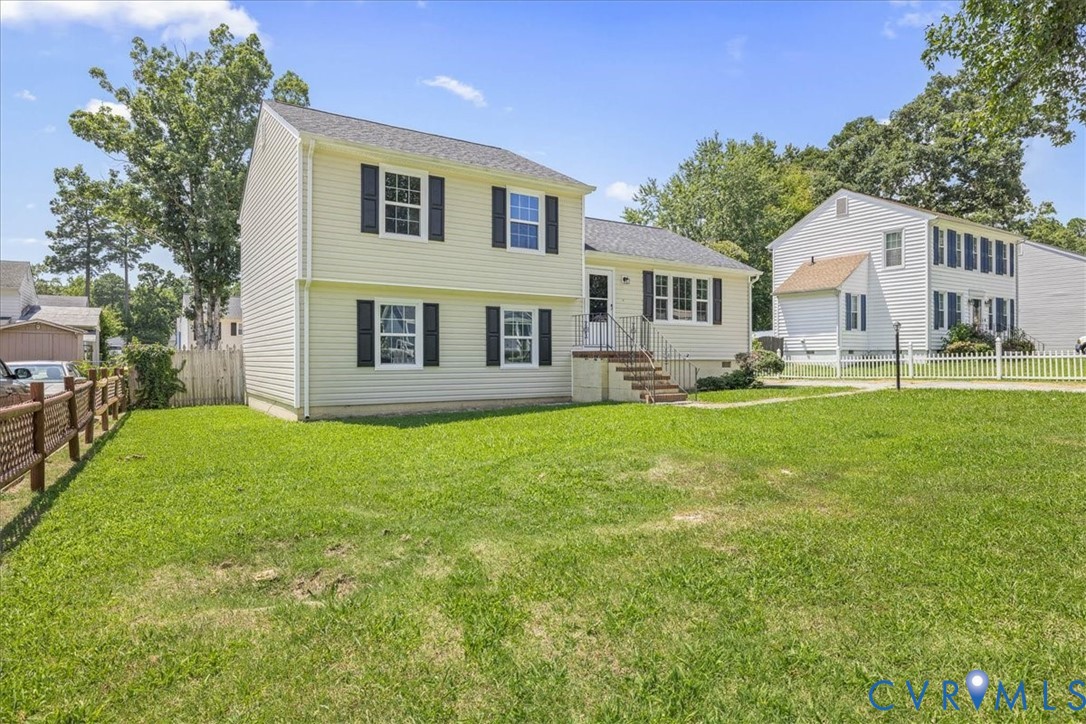View of front of house featuring a fenced backyard