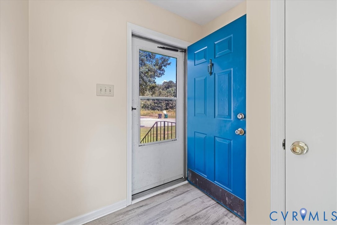 Entryway featuring light wood-type flooring and ba