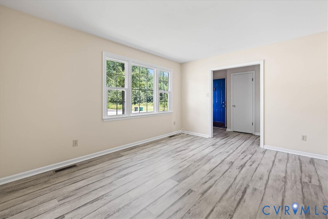 Unfurnished room featuring wood finished floors an