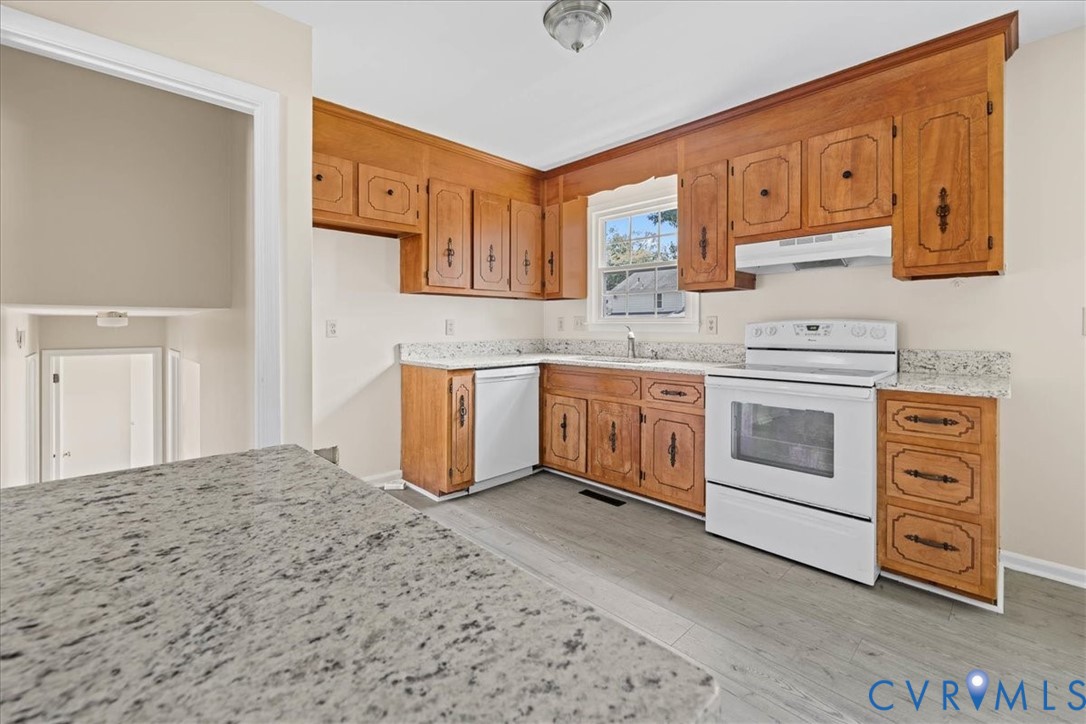 1618 Old Iron Road Hopewell, VA 23860 - Photo 8 of 25 Kitchen with white appliances, brown cabinetry, li