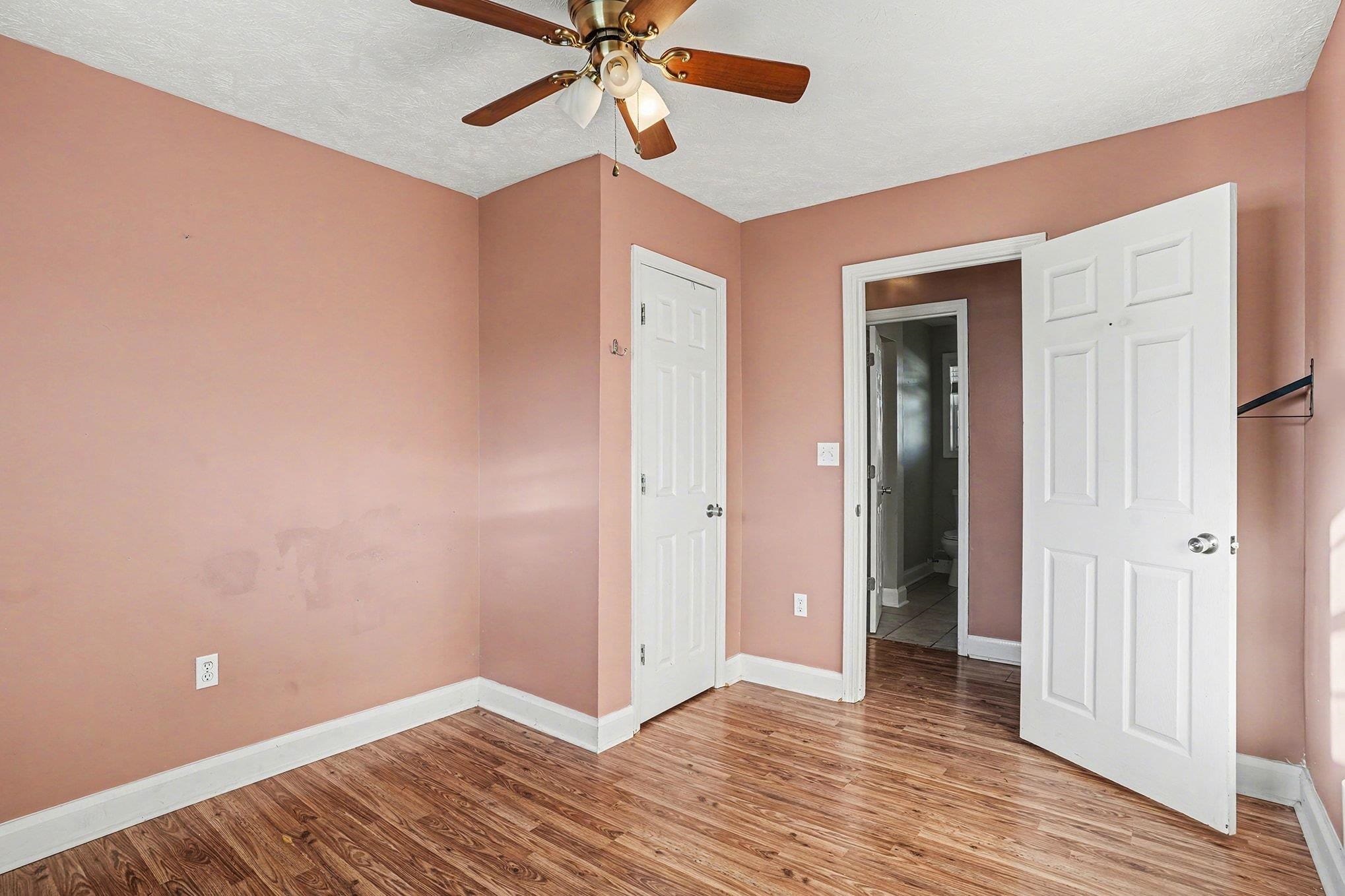 1897 Heritage Road Loris, SC 29569 - Photo 12 of 32 Unfurnished room with wood finished floors, a textured ceiling, and a ceiling fan