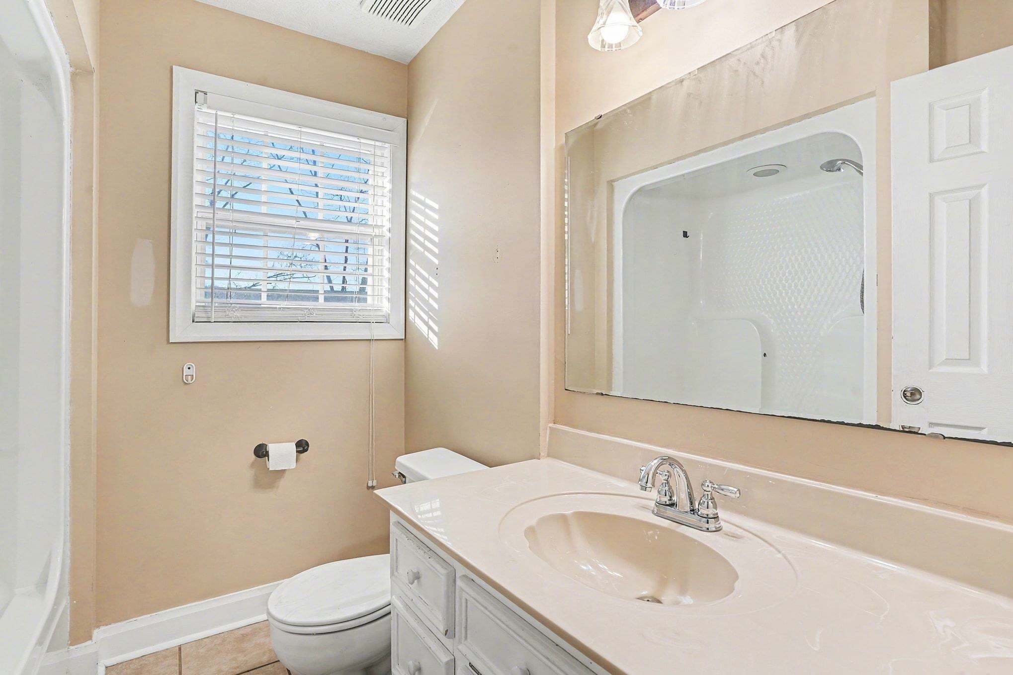 1897 Heritage Road Loris, SC 29569 - Photo 16 of 32 Unfurnished room featuring an accent wall, crown molding, wood finished floors, plenty of natural light, and ceiling fan