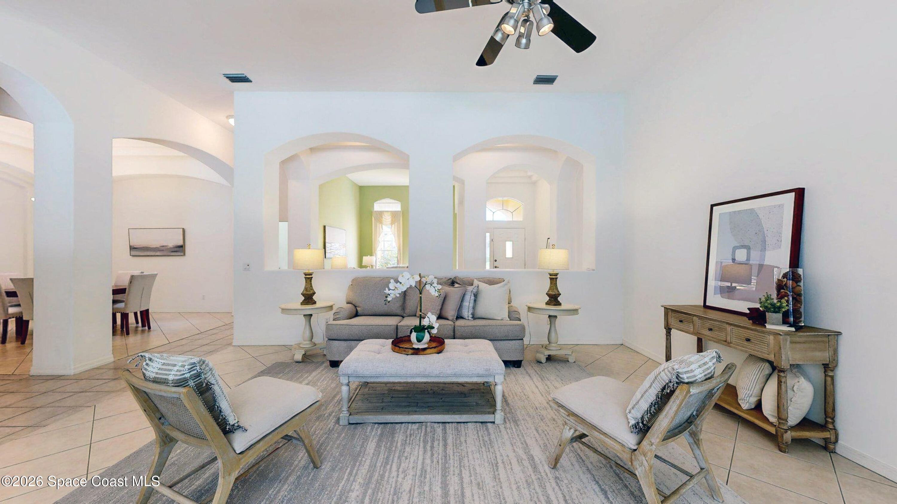 2703 Barrow Drive Merritt Island, FL 32952 - Photo 11 of 43 a living room with couches and a potted plant on table with wooden floor