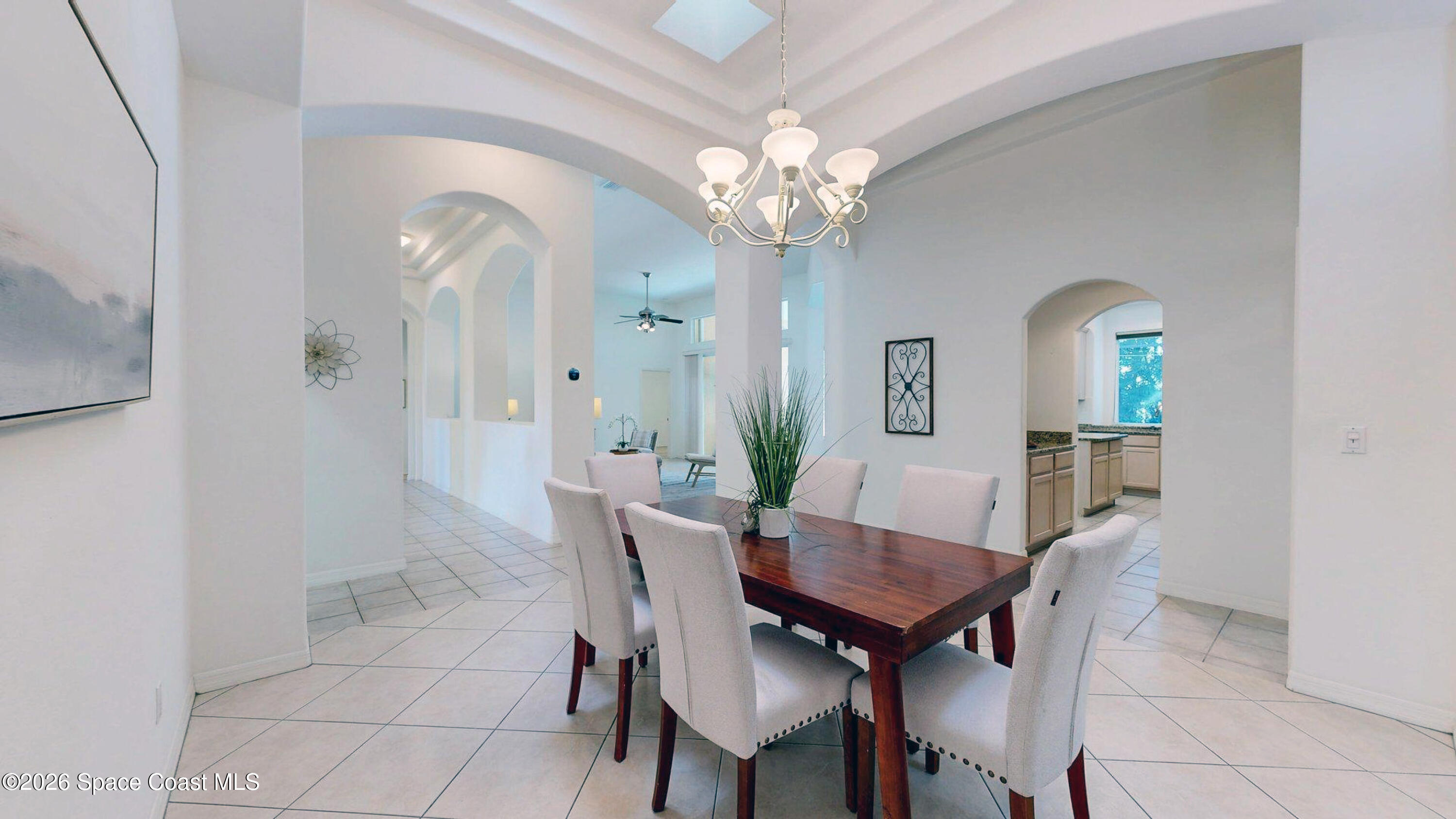 2703 Barrow Drive Merritt Island, FL 32952 - Photo 14 of 43 a view of a dining room with furniture and a chandelier