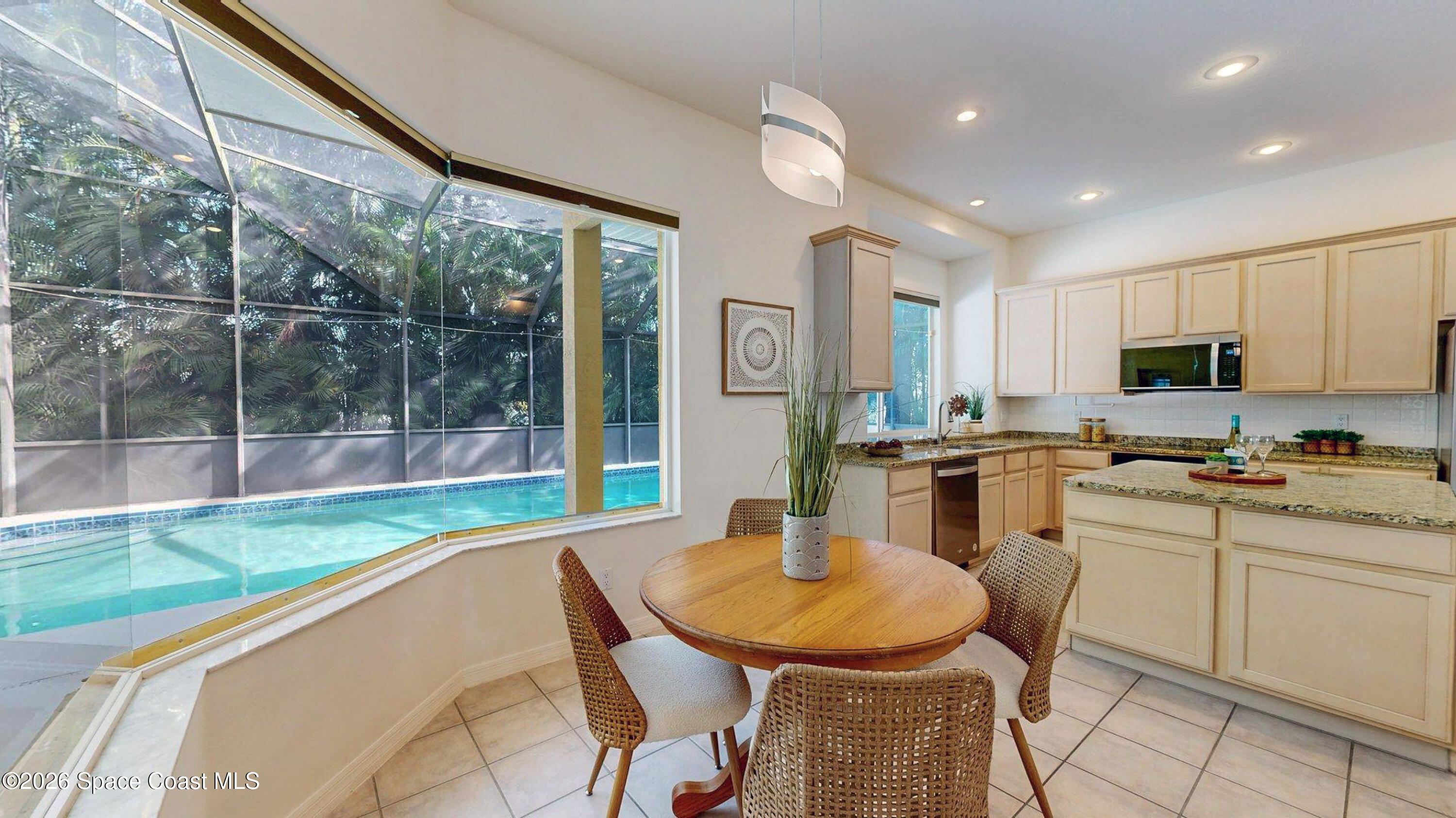 2703 Barrow Drive Merritt Island, FL 32952 - Photo 17 of 43 a kitchen with a table chairs sink and cabinets