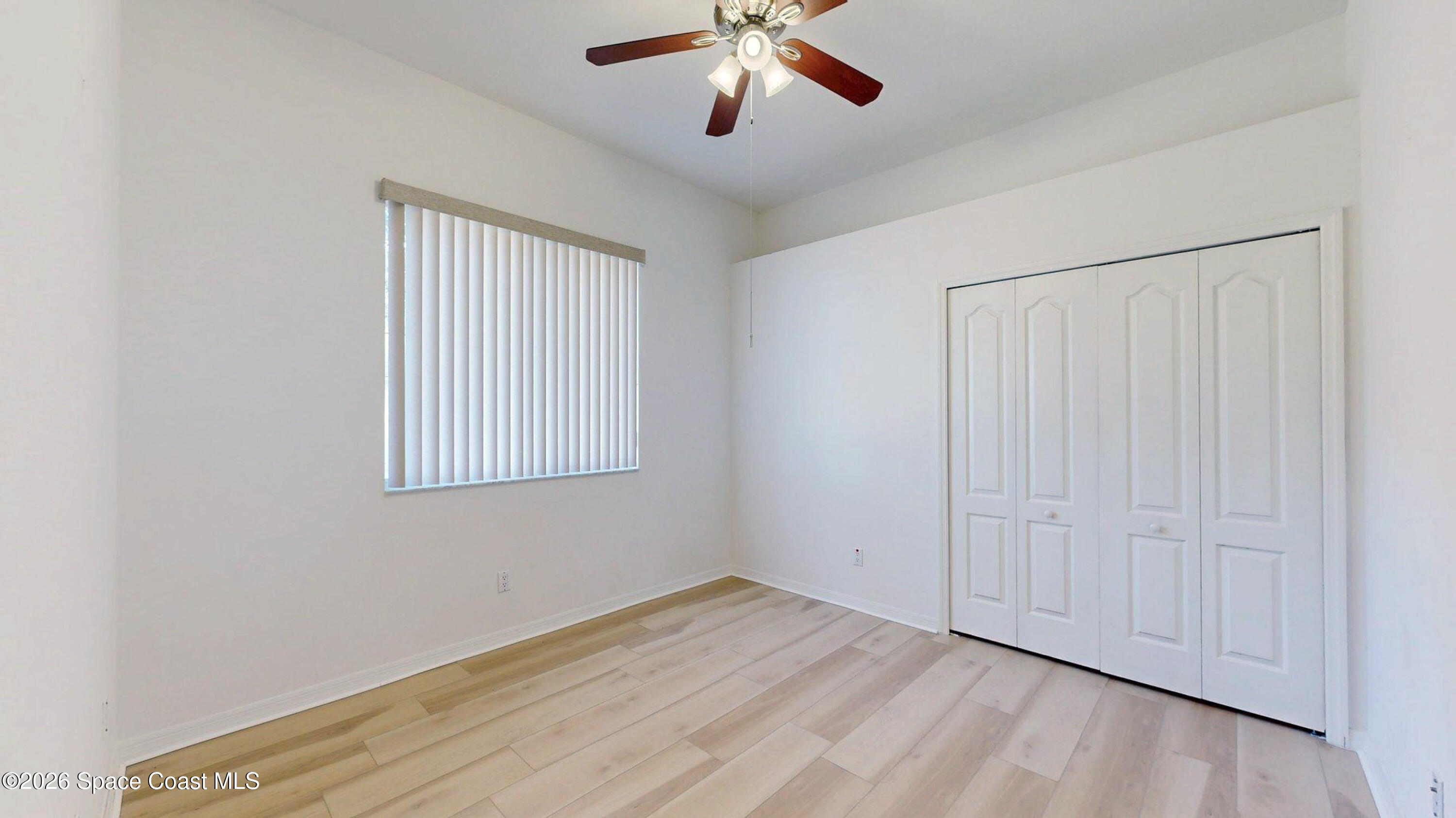 2703 Barrow Drive Merritt Island, FL 32952 - Photo 29 of 43 wooden floor in an empty room with a window