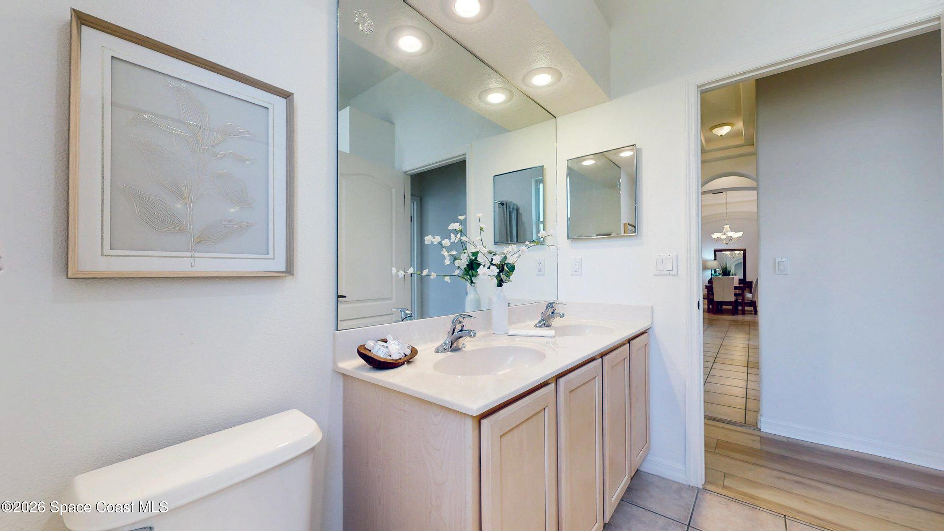 2703 Barrow Drive Merritt Island, FL 32952 - Photo 31 of 43 a bathroom with a toilet sink and mirror