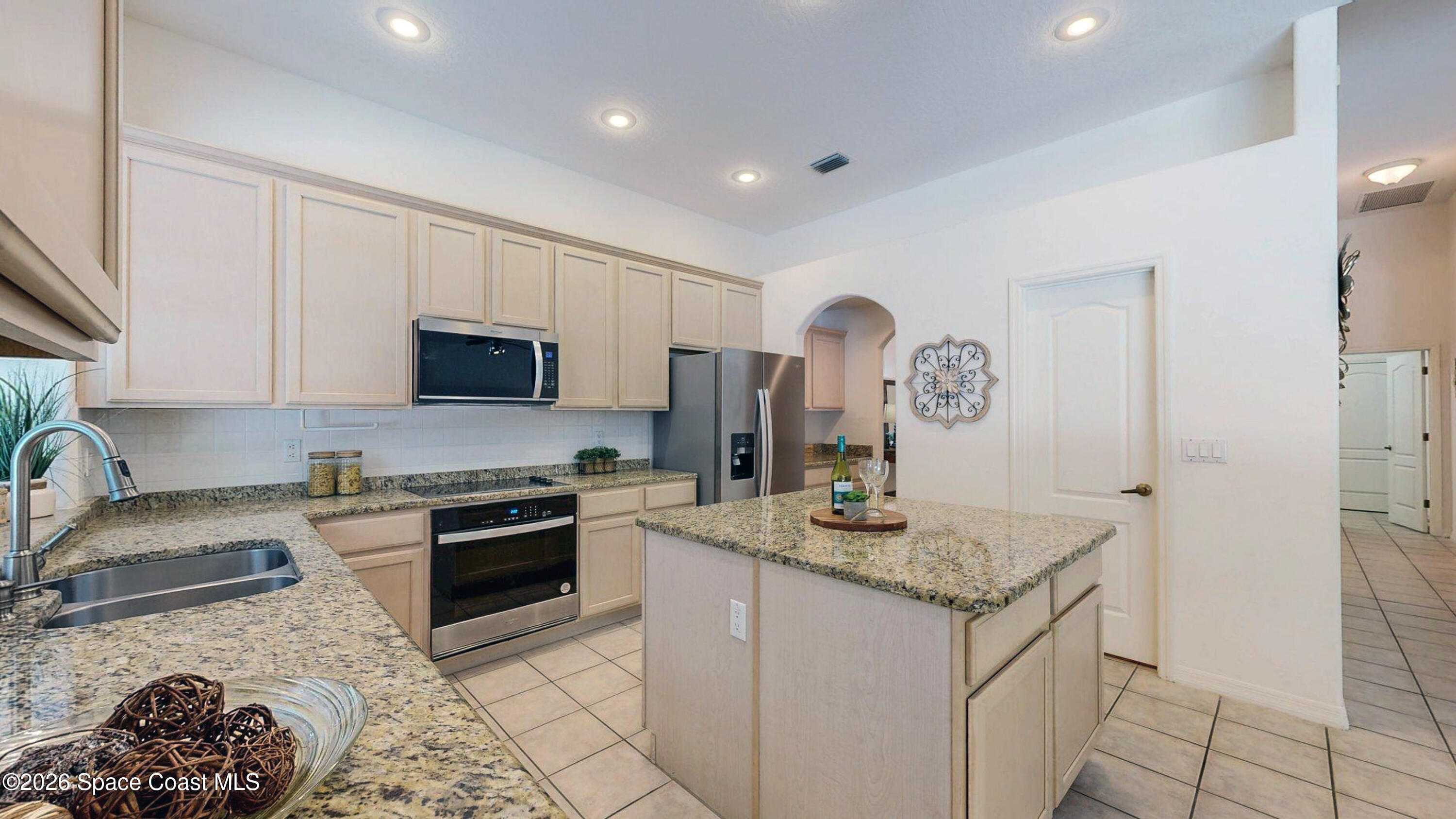 2703 Barrow Drive Merritt Island, FL 32952 - Photo 8 of 43 a kitchen with stainless steel appliances granite countertop a sink stove refrigerator and cabinets