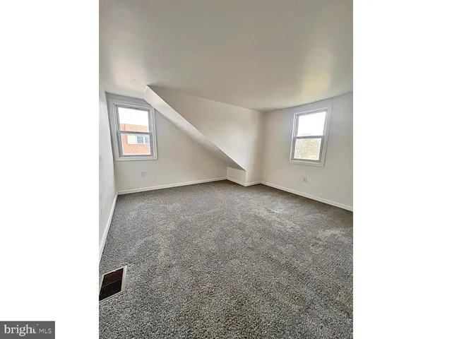 a view of an empty room with windows