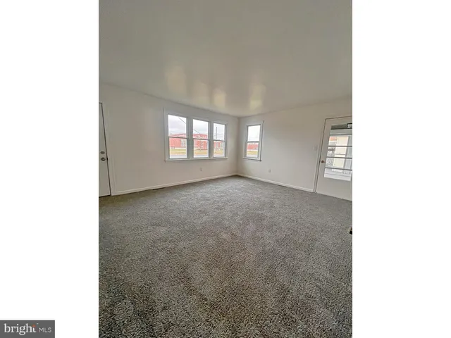 a view of an empty room with windows