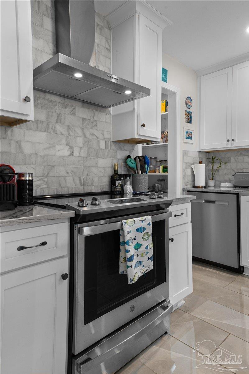 4831 East Olive Road, Unit 1D Pensacola, FL 32514 - Photo 7 of 36 a kitchen with stainless steel appliances a stove and cabinets