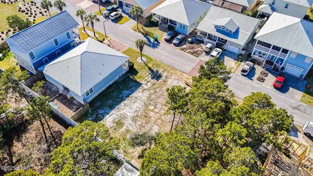 an aerial view of multiple houses with yard