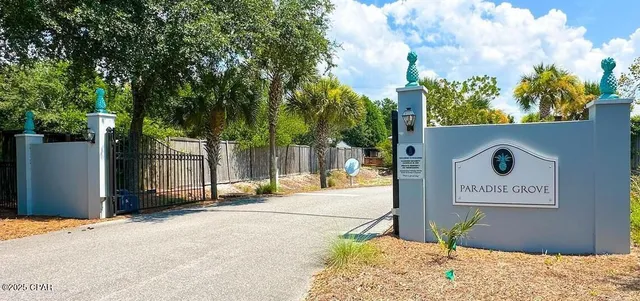 a sign board with a yard and fence