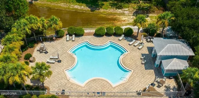 an outdoor sitting area with chairs and wooden floor