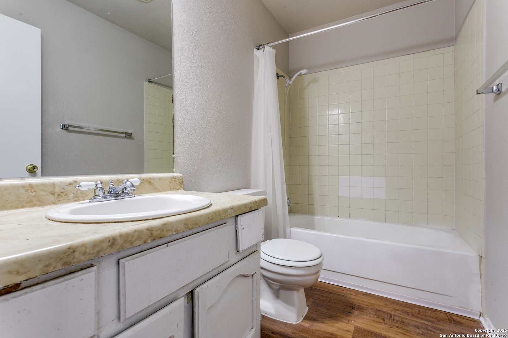 2803 Fred Haise Drive Kirby, TX 78219 - Photo 16 of 24 a bathroom with a granite countertop sink toilet and shower