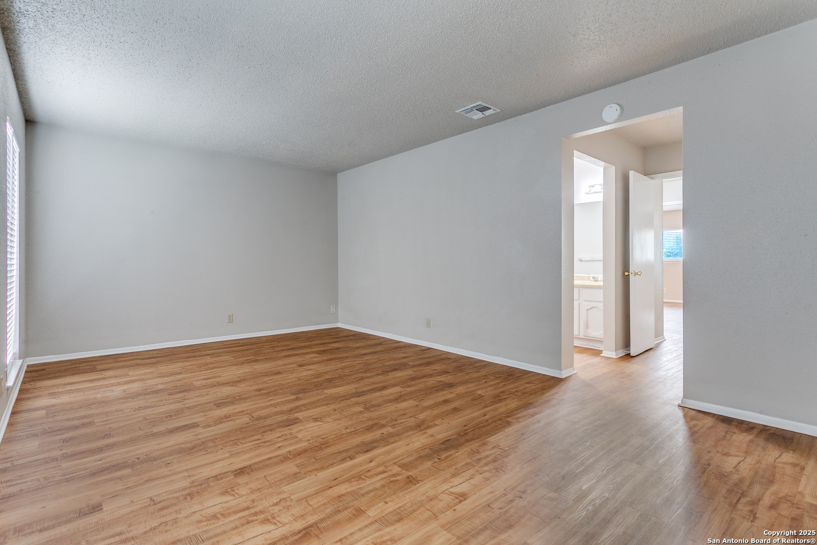 2803 Fred Haise Drive Kirby, TX 78219 - Photo 19 of 24 wooden floor in an empty room