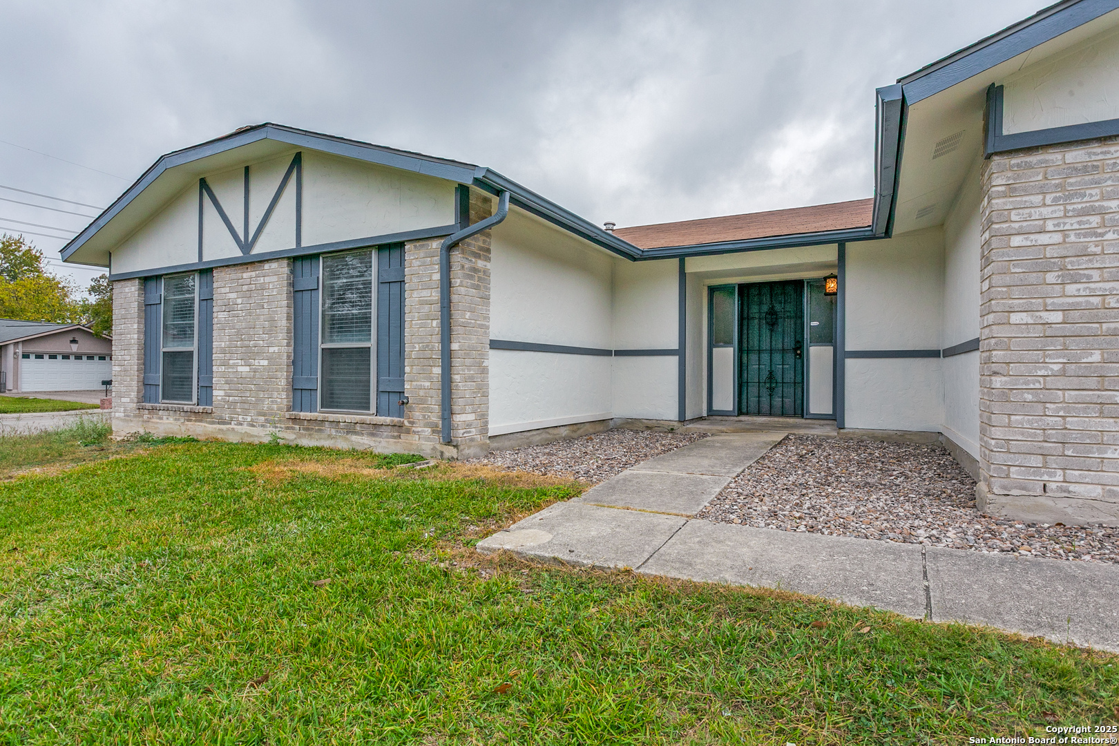 2803 Fred Haise Drive Kirby, TX 78219 - Photo 3 of 24 a front view of a house with a yard and garage