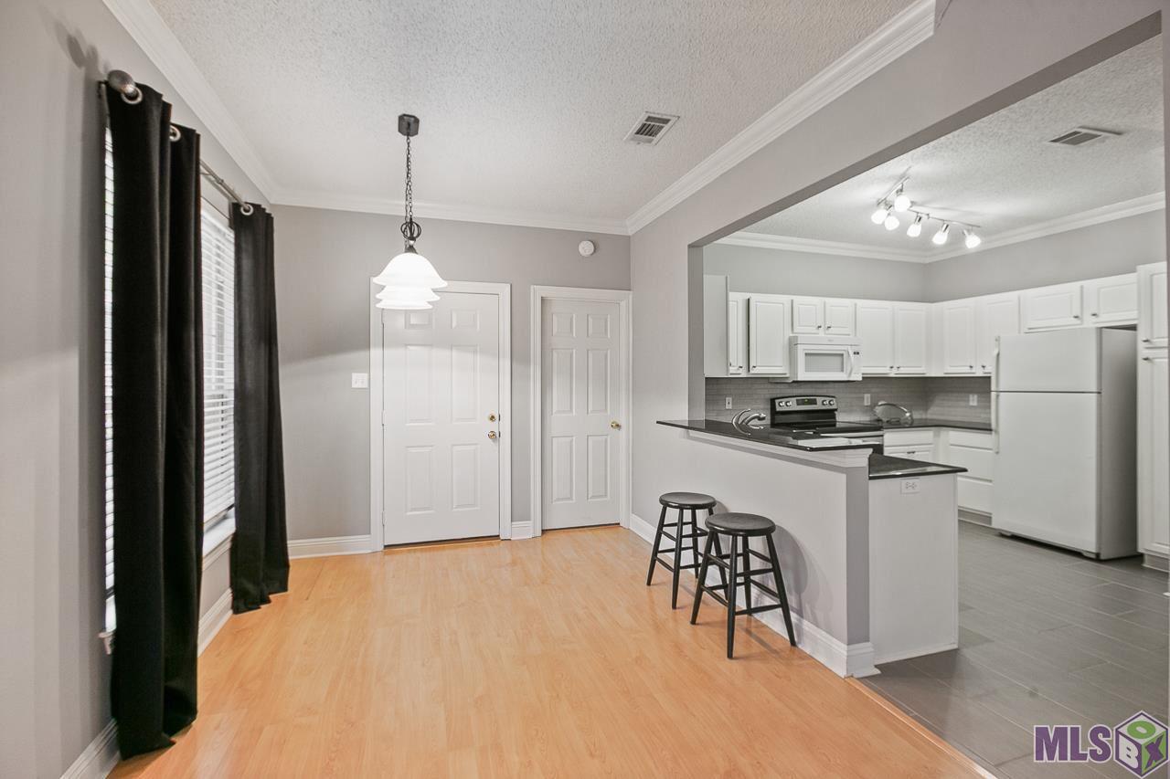 4464 Highland Road, Unit 807 Baton Rouge, LA 70808 - Photo 5 of 25 Dining Table and Balcony Access