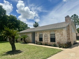 2705 Parrott Avenue Rosenberg, TX 77471 - Photo 2 of 37 a view of a brick house with a yard and large trees