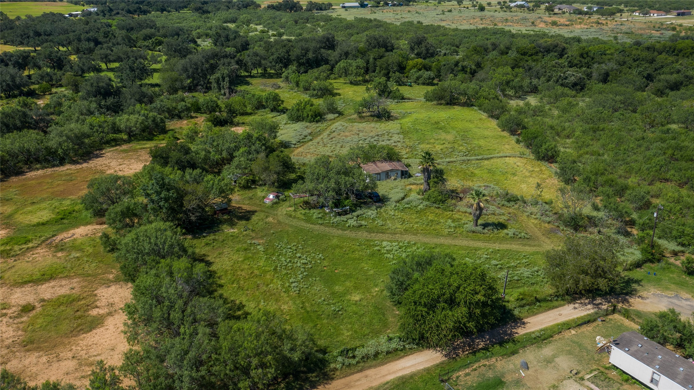345 Pinn Road Lytle, TX 78052 - Photo 9 of 11 a view of a green field with lots of bushes