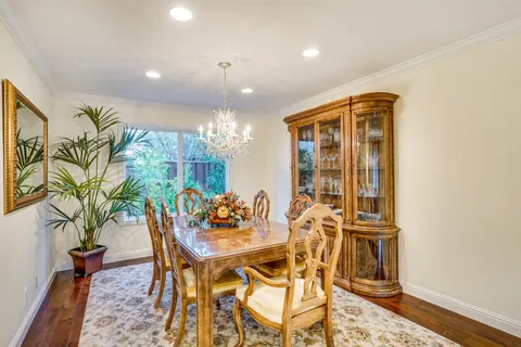 a view of a dining room with furniture and a potted plant